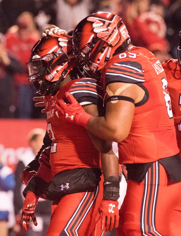 Utah Utes offensive lineman Lo Falemaka (69) celebrates with Utah running back Zack Moss (2) after he scored a touchdown, in PAC-12 football action Utah Utes vs. Colorado Buffaloes at Rice-Eccles stadium, Saturday, November 25, 2017.