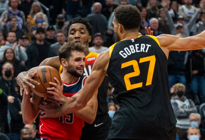 (Rick Egan | The Salt Lake Tribune) Utah Jazz guard Donovan Mitchell (45) holds on to the ball resulting in a jump ball with Washington Wizards guard Raul Neto (19), in the final minute of the game, in NBA action between the Utah Jazz and the Washington Wizards, at Vivint Arena on Saturday, Dec. 18, 2021.