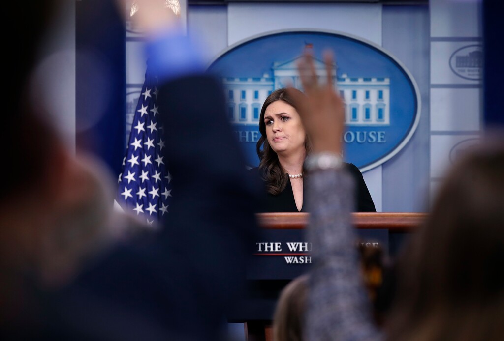 White House press secretary Sarah Huckabee Sanders listens to a reporter's question as other raise their hands to ask a question, during the daily press briefing at the White House, Tuesday, Dec. 12, 2017, in Washington. (AP Photo/Alex Brandon)
