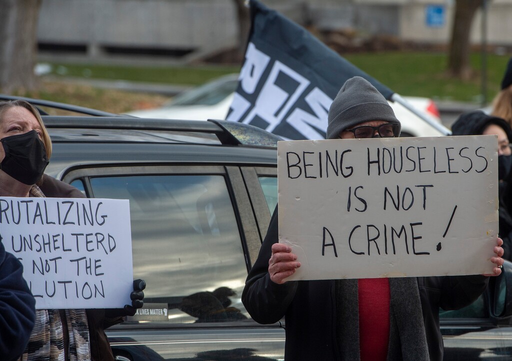 (Rick Egan | The Salt Lake Tribune) More than 100 Black Lives Matter and other groups protest the way the health department has been forcing people experiencing homelessness to move in the middle of a pandemic and the coldest time of the year, in front of the Salt Lake Public Health Center onFriday, Dec. 18, 2020.