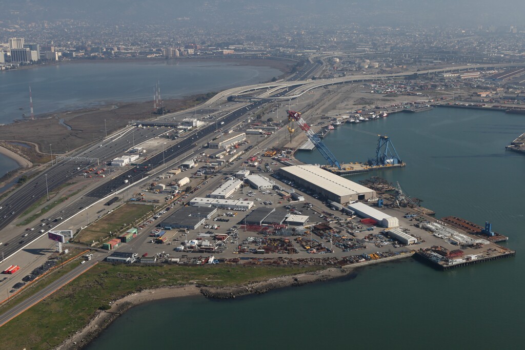 (Photo courtesy of No Coal in Oakland) This 2013 photo shows the site of a proposed export terminal in Oakland, known as West Gateway, located next to the Bay Bridge toll plaza. Utah’s largest coal producer Bowie Resource Partners has subleased the 34-acre city-owned parcel to build and operate a rail-to-ship bulk-freight loading marine terminal for shipping Utah coal to Asian markets. Bowie is also funding a lawsuit against Oakland’s ban on coal handling, now being tried in California’s federal court. Citing impacts to public health, the city enacted the ban in 2016, prompting the lawsuit from developer Phil Tagami, who alleges the city breached its contract with him.