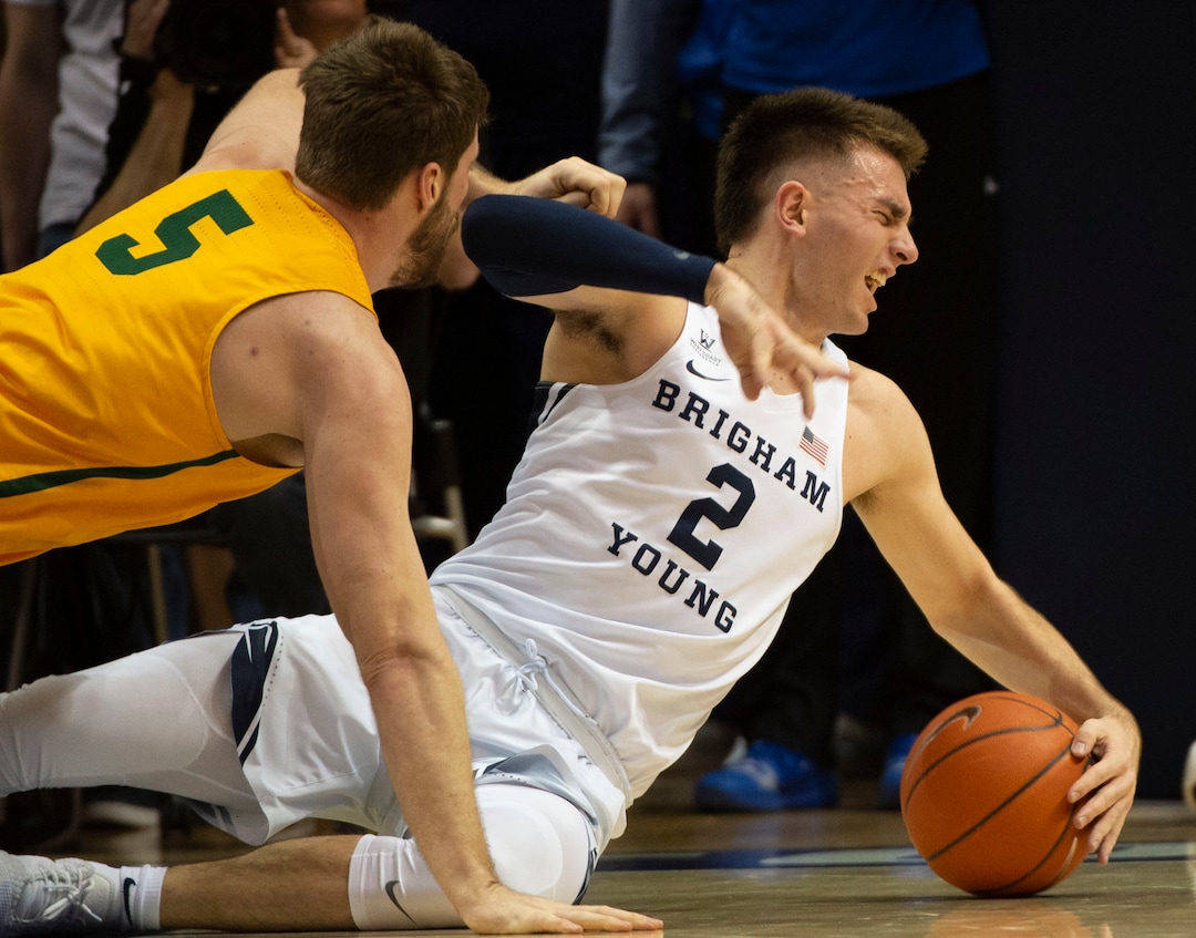(Rick Egan  |  The Salt Lake Tribune)      San Francisco Dons center Jimbo Lull (5) goes for a loose ball along with Brigham Young Cougars guard Zac Seljaas (2), in WCC basketball action at the Marriott Center, Thursday, February 21, 2018.