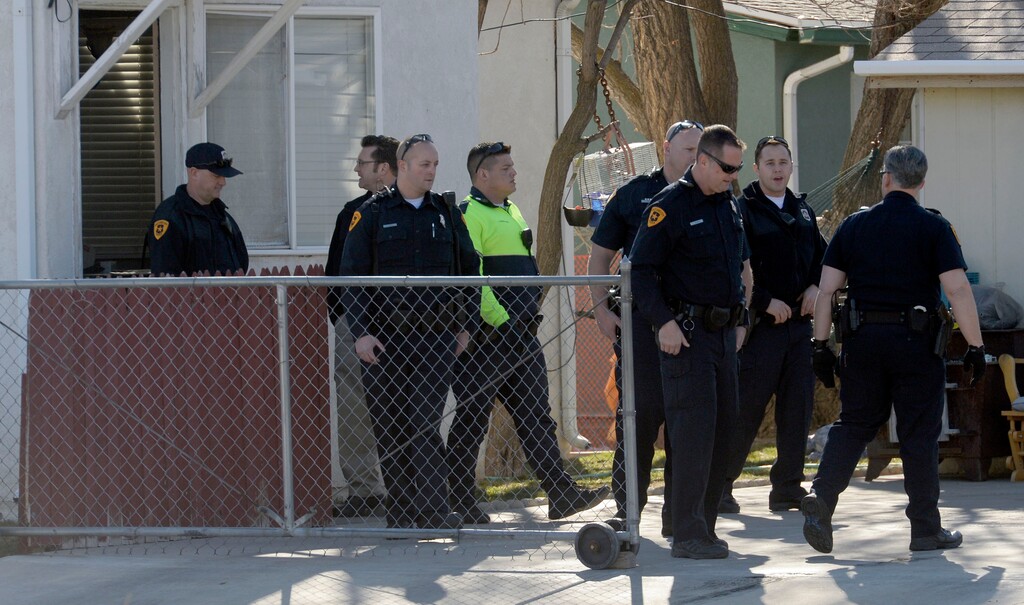 Al Hartmann | The Salt Lake Tribune
Salt Lake City police search house at southwest corner of 1400 W. and Hayes Ave. (950 S.) Tuesday Feb. 24. A man believed to be involved in an aggravated assault and attempted kidnapping abandoned his car in the area. Three nearby schools were put on precautionary lock down while the neighborhood was being searched for the suspect.