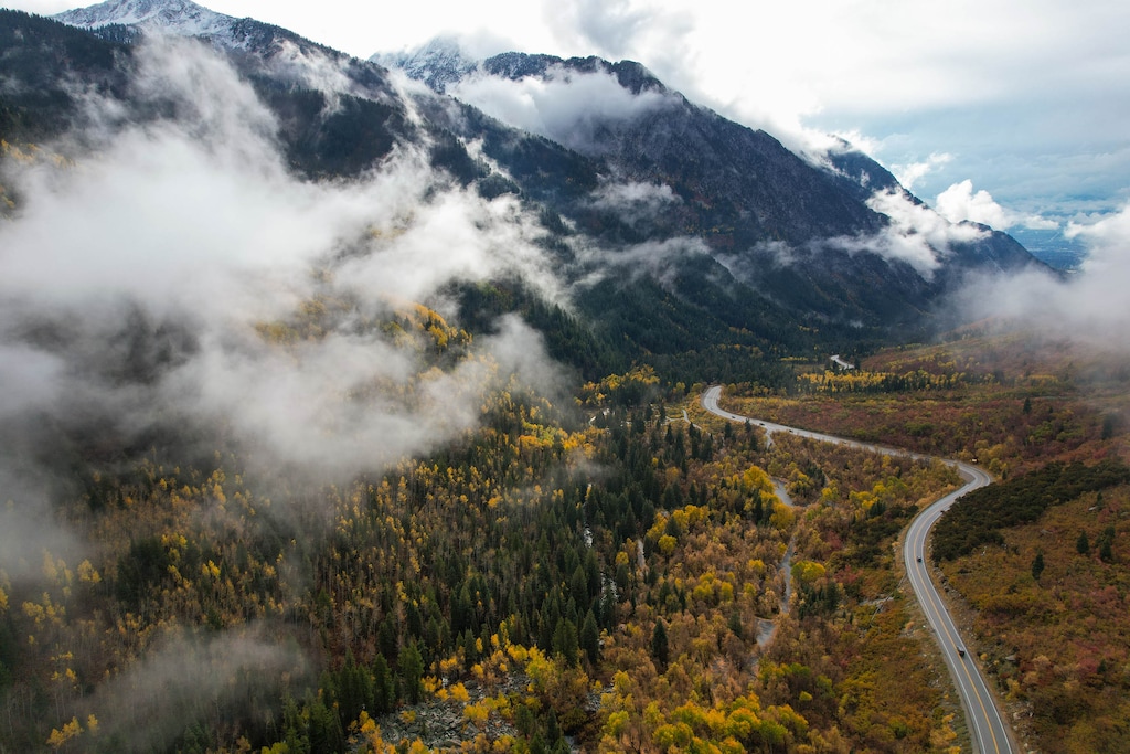 (Francisco Kjolseth  | The Salt Lake Tribune) Low clouds obscure fall colors in this 2024 image of Little Cottonwood Canyon. A teen died after falling more than 100 feet Wednesday while hiking Devil's Castle Trail, at the top of the canyon.