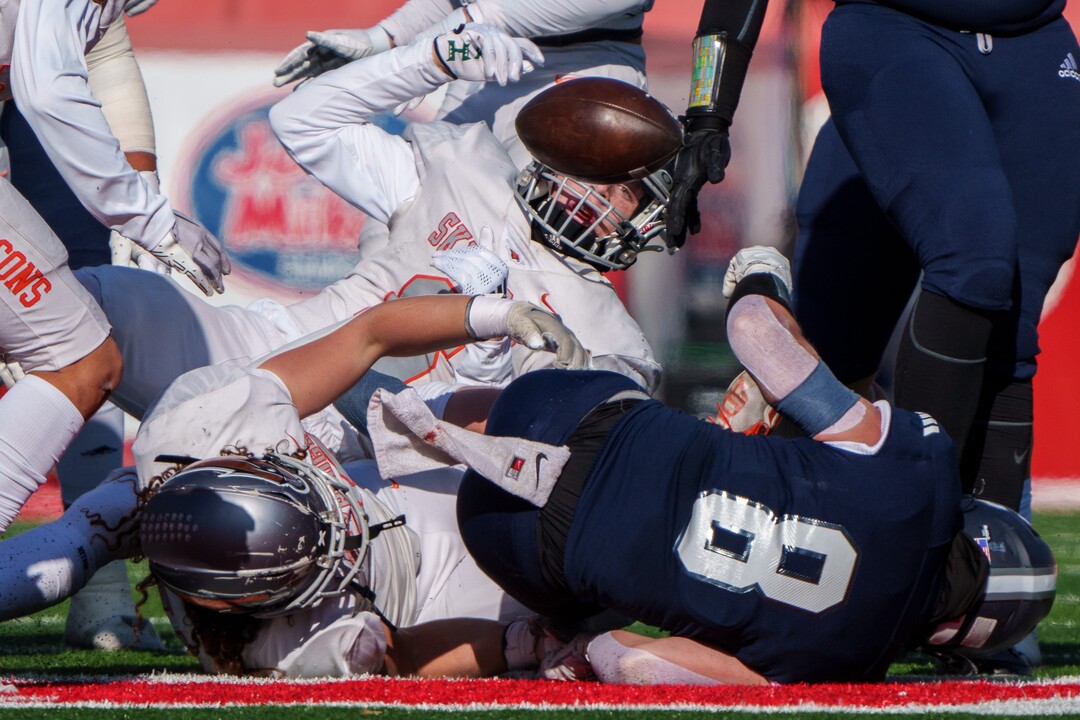 (Trent Nelson  |  The Salt Lake Tribune) Skyridge defenders knock the ball from Corner Canyon's Drew Patterson (8) in the 6A high school football championship game at Rice-Eccles Stadium in Salt Lake City on Friday, Nov. 18, 2022.