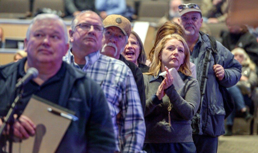 Leah Hogsten  |  The Salt Lake Tribune  Jodi Monaco, right, waits to ask questions from the mayor during the water quality meeting. As Sandy City declared Sunday evening that all of its water is now safe to drink, residents were asking why many of them were allowed to drink possibly tainted water for a week before they heard about problems, Feb.18, 2019 at a town hall meeting to address the issue. Problems began Feb. 6, when a fluoride pump malfunctioned because of a power outage. It flooded parts of the water system with huge amounts of fluoride Ñ which can cause health problems, plus the acidic fluoride also corroded pipes in some homes to release also-dangerous heavy metals such as lead and copper.