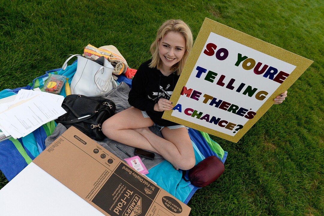 (Francisco Kjolseth  |  The Salt Lake Tribune)  Laila Grigley of Lehi holds the sign her friend Jade Dansie plans to present as she waits in line nearby to audition for "American Idol" in downtown Provo on Wednesday morning, Aug. 23, 2017, for the revived show, which is moving to ABC and will air in early 2018.