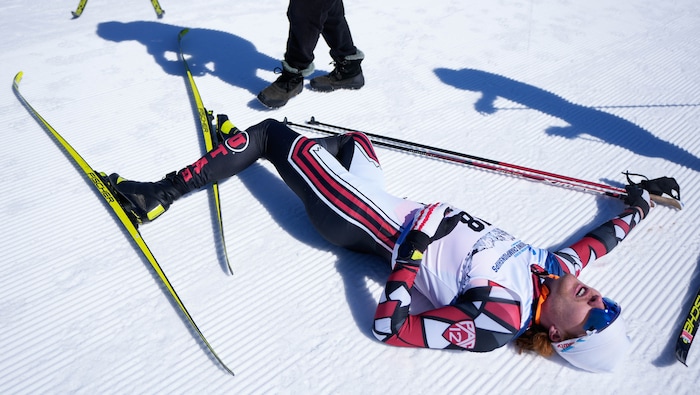 (Francisco Kjolseth | The Salt Lake Tribune) Bjorn Riksaasen of the University of Utah collapses at the finish line after competing in the men’s 10K classic during the NCAA Skiing Championships held at the Soldier Hollow Nordic Center on Thursday, March 10, 2022 in Midway, Utah. 