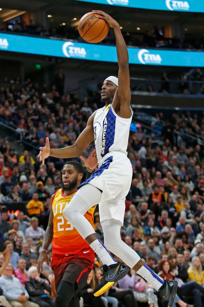 Indiana Pacers forward Justin Holiday, left, goes to the basket as Utah Jazz forward Royce O'Neale (23) defends in the first half of an NBA basketball game Monday, Jan. 20, 2020, in Salt Lake City. (AP Photo/Rick Bowmer)