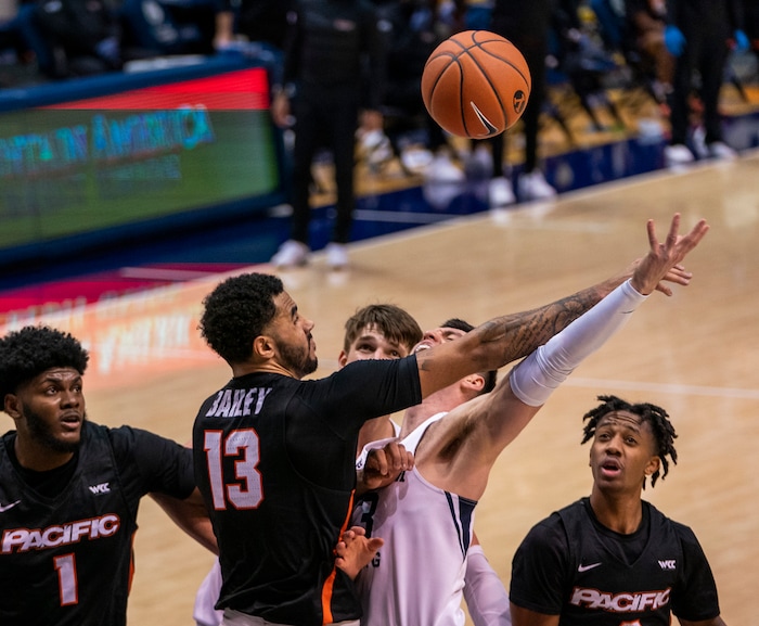 (Rick Egan | The Salt Lake Tribune)  Brigham Young Cougars guard Alex Barcello (13) is fouled by Pacific Tigers forward Jeremiah Bailey (13), in basketball action at the Marriott Center in Provo, on Saturday, Jan. 30, 2021.