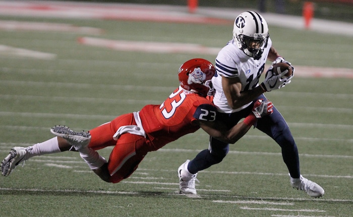 BYU's wide receiver Micah Simon is tackled by Fresno State's Juju Hughes during the second half of an NCAA college football game in Fresno, Calif., Saturday, Nov. 4, 2017. Fresno State won the game 20-13. (AP Photo/Gary Kazanjian)