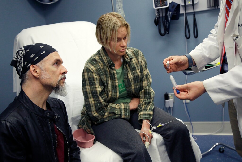 In this May 11, 2016 photo, University of Massachusetts Medical School student Dylan Perry, far right, demonstrates a nasal Naloxone for emergency treatment of opioid overdose to actor-patients coping with addiction during a simulation at the medical school in Worcester, Mass. Many U.S. medical schools are expanding their training to help students fight opioid abuse. New training programs at many schools teach students to prescribe opioid painkillers only as a last resort, and to evaluate all patients for signs of drug abuse. (AP Photo/Elise Amendola)