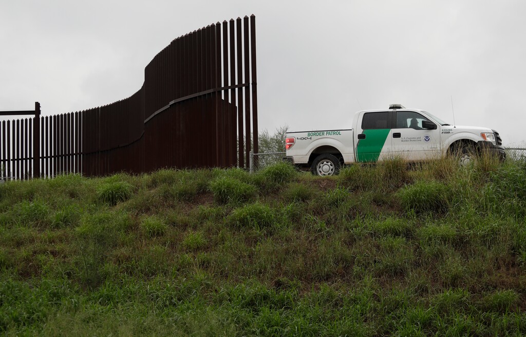 (Eric Gay | The Associated Press) This Nov. 13, 2016, file photo shows a U.S. Customs and Border Patrol agent passes along a section of border wall in Hidalgo, Texas. The U.S. government has awarded a $167 million contract to build 8 miles of border wall in south Texas. U.S. Customs and Border Protection announced the contract Wednesday, Nov. 14, 2018. Construction will begin in February.