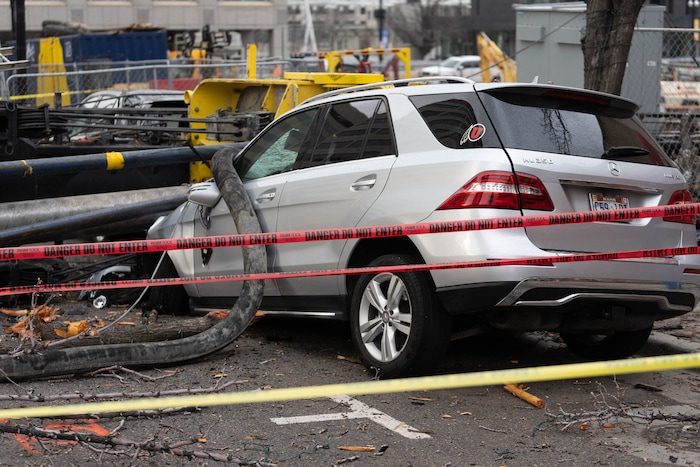 (Francisco Kjolseth | The Salt Lake Tribune) A collapsed drill rig is seen on Wednesday, March 16, 2022, at the intersection of State Street and 200 South. The rig toppled over Tuesday night at the site of the new Astra Tower, crushing two unoccupied parked cars and sending the crane operator to the hospital in serious condition.