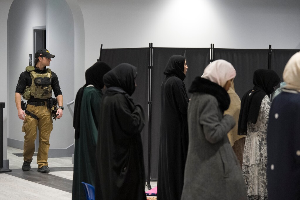 (Bethany Baker  |  The Salt Lake Tribune) Security officer guards an entrance as people pray at Utah Islamic Society for Ramadan in West Jordan on Tuesday, Feb. 24, 2026.