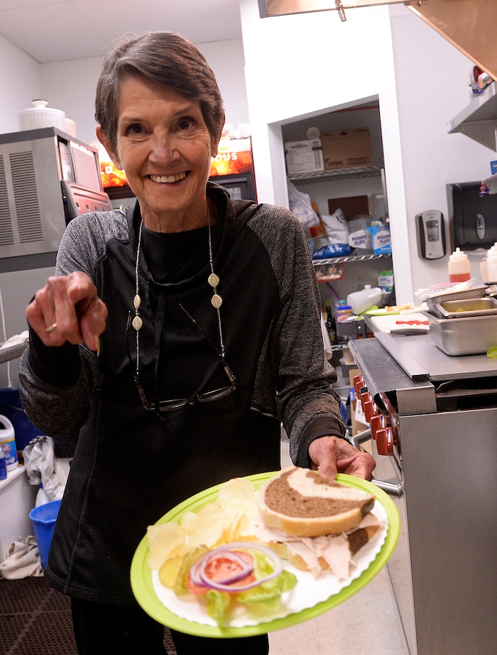 (Al Hartmann  |  The Salt Lake Tribune) Karleen Reilly hands over a fresh turkey sandwich to a customer at Uptown Fare in Park City. She has announced her retirement on March 1, so this will be her last Sundance Film Festival.