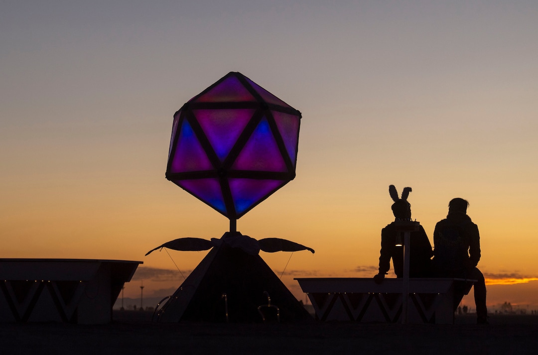 (Rick Egan  |  The Salt Lake Tribune)   Burning Man participants sit next to "Electric Plantern"  by Lanterns Schmanters, as they wait for the sunrise, at Burning Man, Saturday, Aug. 31, 2019.