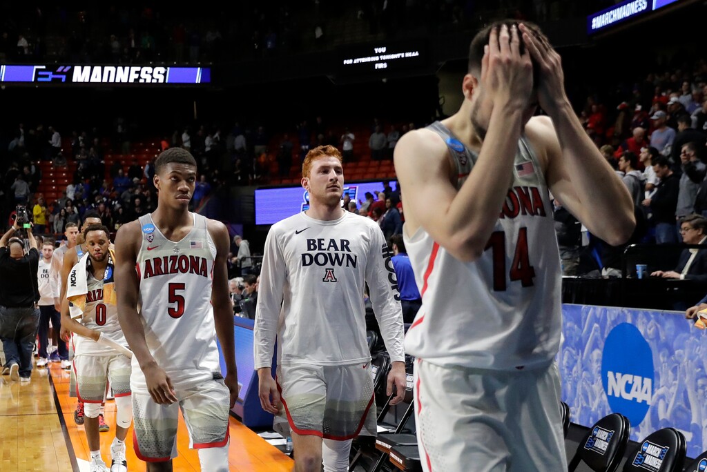 Arizona's Brandon Randolph (5) and Dusan Ristic (14) walk off the court with teammates after Arizona was upset by Buffalo, 89-68, in a first-round game of the NCAA men's college basketball tournament Thursday, March 15, 2018, in Boise, Idaho. (AP Photo/Ted S. Warren)