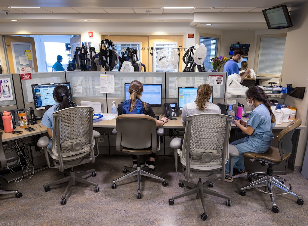 (Charlie Ehlert | University of Utah Health) Health care workers attend to patients in the intensive care unit at University Hospital in Salt Lake City in March.