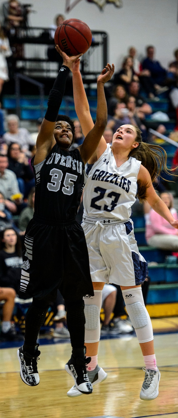 (Steve Griffin  |  The Salt Lake Tribune)  Copper Hills guard Breaunna Gillen blocks the shot of Rivertob's McKenzie McCombs during the Riverton versus Copper Hills girl's basketball game at Cooper Hill s High School in West Jordan Thursday February 1, 2018.