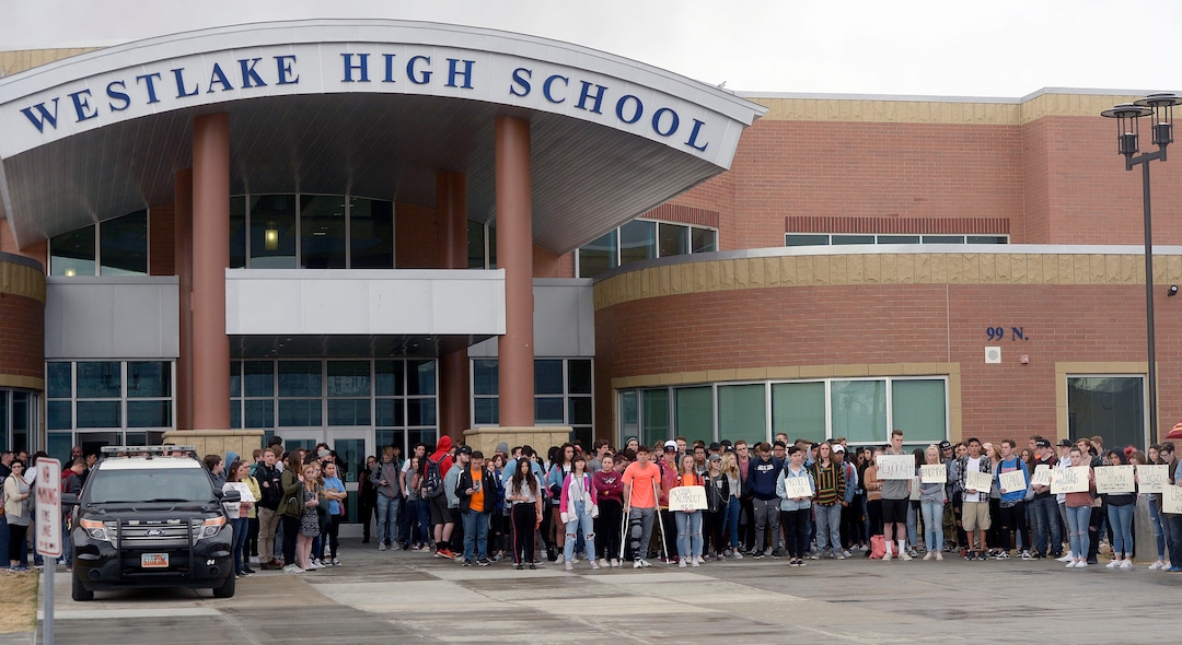 (Al Hartmann  |  The Salt Lake Tribune) 	About 80 students at Westlake High School in Saratoga Springs left class and stood together in silence at the front entrance of the school Wednesday March 14, 2018 to remember the 17 students who died in a school shooting in Florida.  They held posters of the names of those killed. 