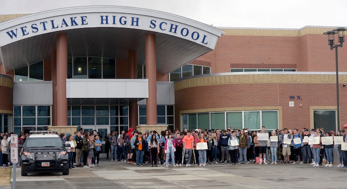 (Al Hartmann  |  The Salt Lake Tribune) 	
About 80 students at Westlake High School in Saratoga Springs left class and stood together in silence at the front entrance of the school Wednesday March 14, 2018 to remember the 17 students who died in a school shooting in Florida.  They held posters of the names of those killed. 