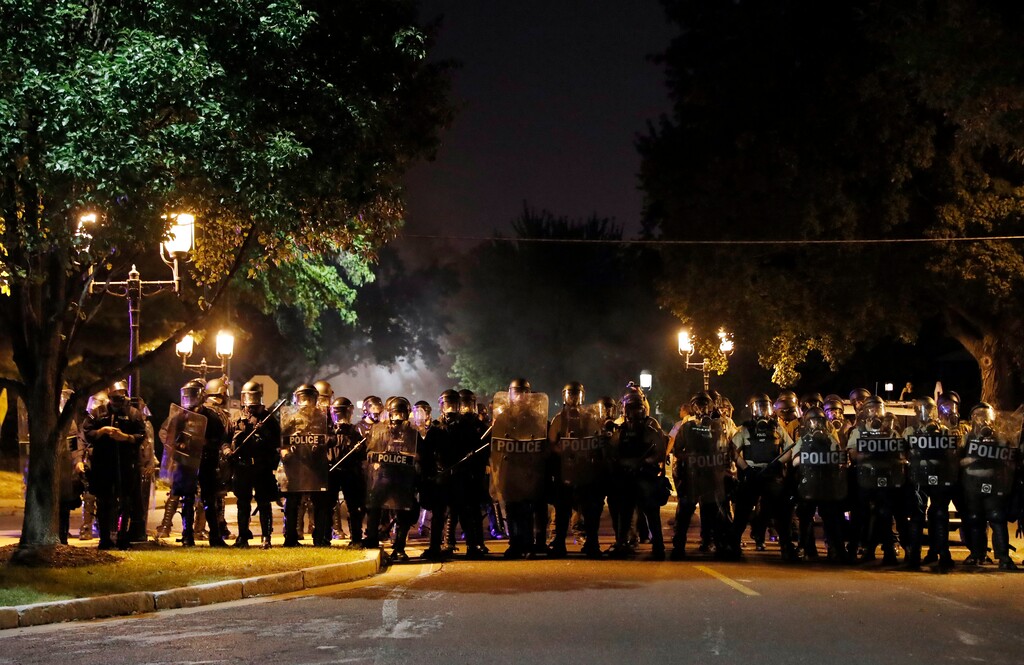 Police line up as protesters gather, Friday, Sept. 15, 2017, in St. Louis, after a judge found a white former St. Louis police officer, Jason Stockley, not guilty of first-degree murder in the death of a black man, Anthony Lamar Smith, who was fatally shot following a high-speed chase in 2011. (AP Photo/Jeff Roberson)
