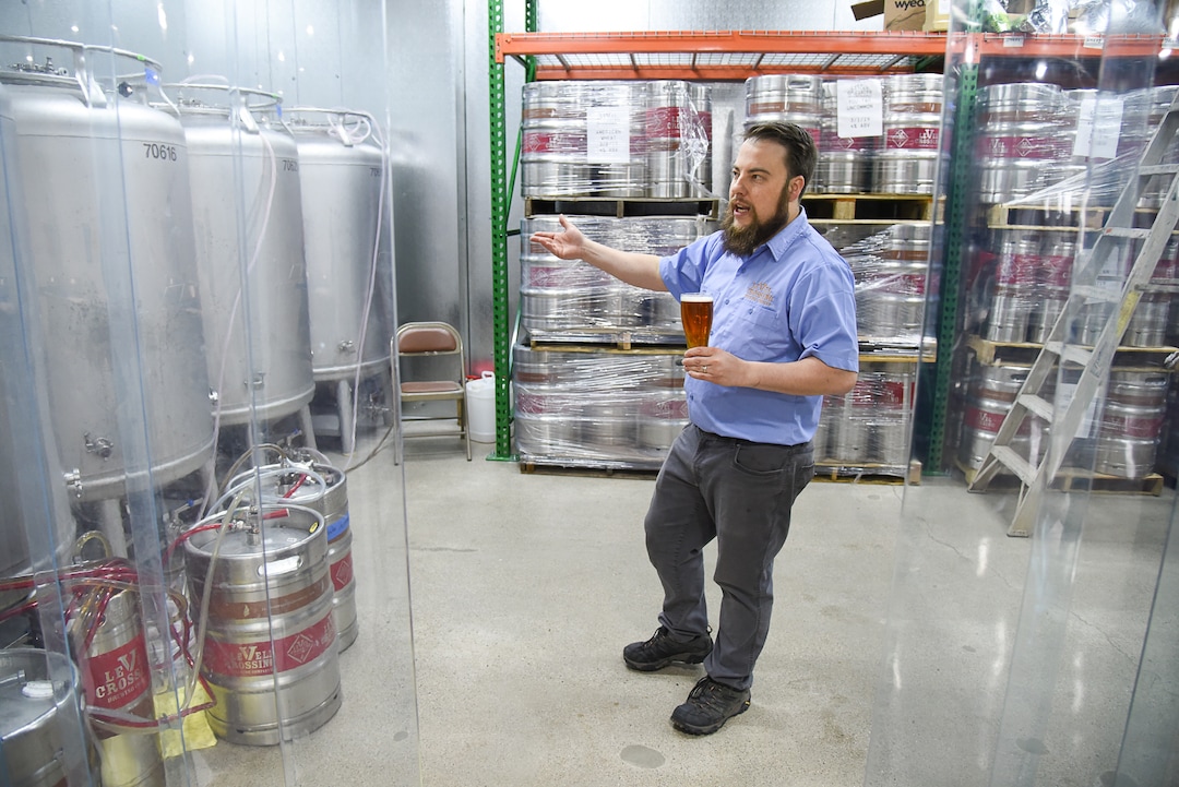 (Francisco Kjolseth  |  The Salt Lake Tribune)  Chris Detrick, head brewer at Level Crossing Brewing Co., gives a tour of the cold storage area.