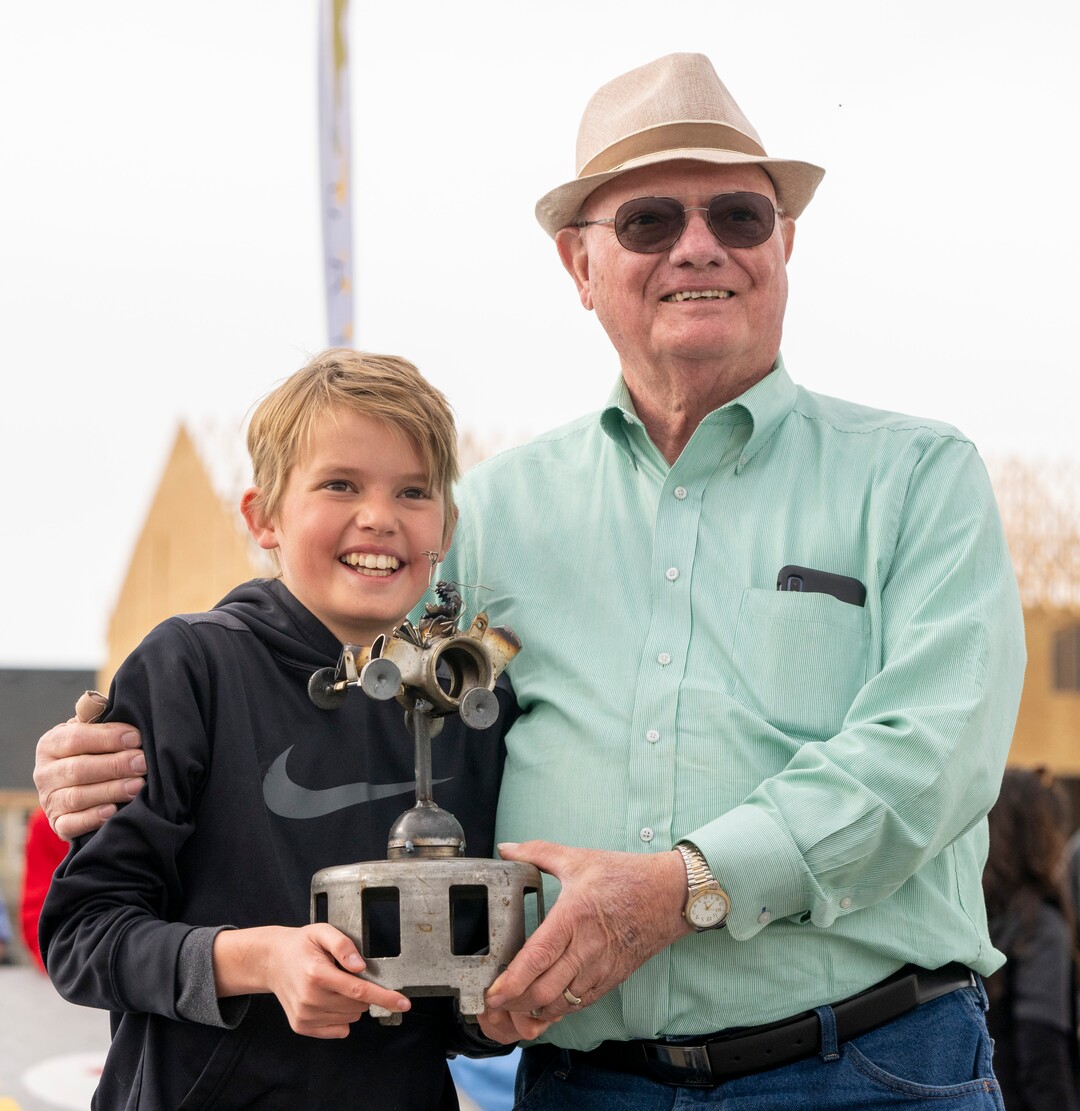 (Rick Egan | The Salt Lake Tribune)  Parker Boyer holds the trophy for first place in the Freestyle division with his grandpa Ron Norviel, during the Daybreak Soap Box Derby, on Saturday, April 24, 2021.