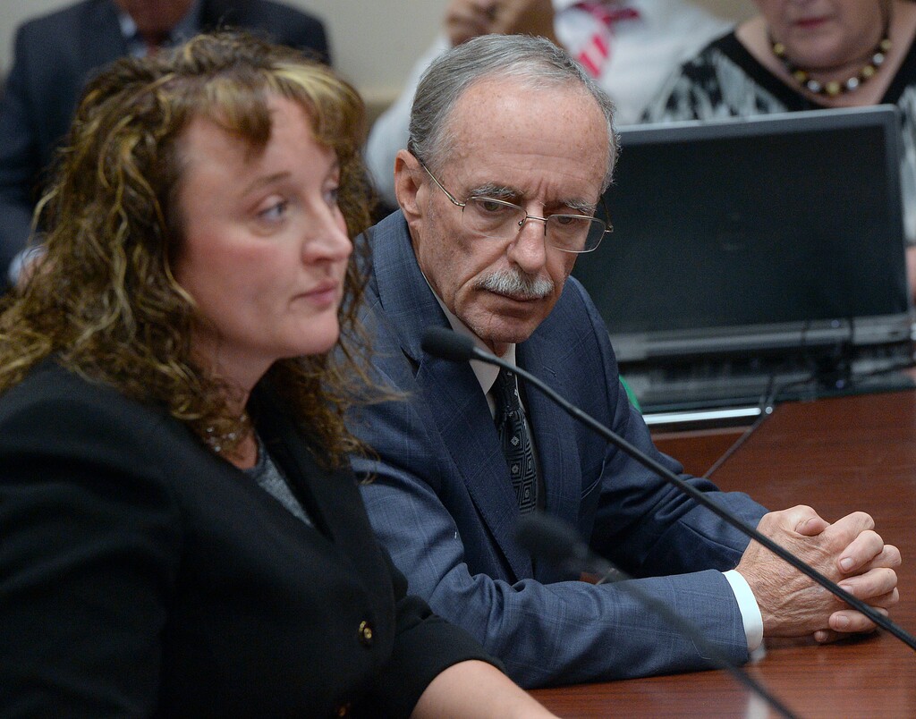 In this Oct. 4, 2016, photo, Salt Lake County County Recorder Gary Ott sits with his chief deputy Julie Dole before the Salt Lake County Council's findings of the County Auditor's performance audit of his office in Salt Lake City. Salt Lake County District Attorney Sim Gill and Salt Lake County Mayor Ben McAdams said in a statement Thursday, July 20, 2017, that Ott, who has been placed under his family's guardianship after more than a year public questions about his mental capacity will resign his office, would resign his office Aug. 1. (Al Hartmann/The Salt Lake Tribune via AP)