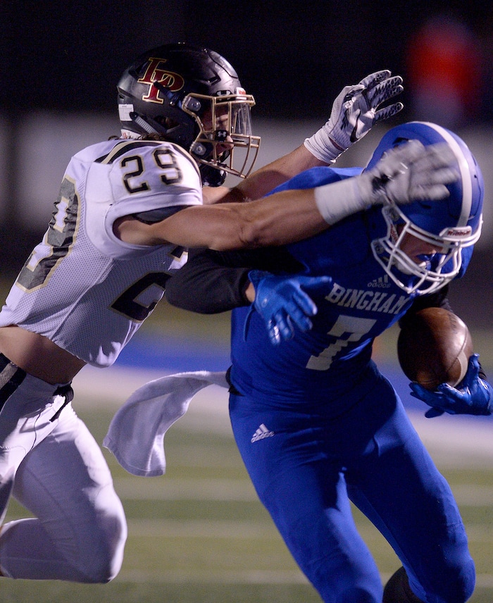 (Leah Hogsten | The Salt Lake Tribune) Lone Peak's Jacob Mumford takes down Bingham's wide receiver Brayden Cosper. Bingham High School leads Lone Peak High School, 14-3 during their game Friday, September 28, 2017 in South Jordan.