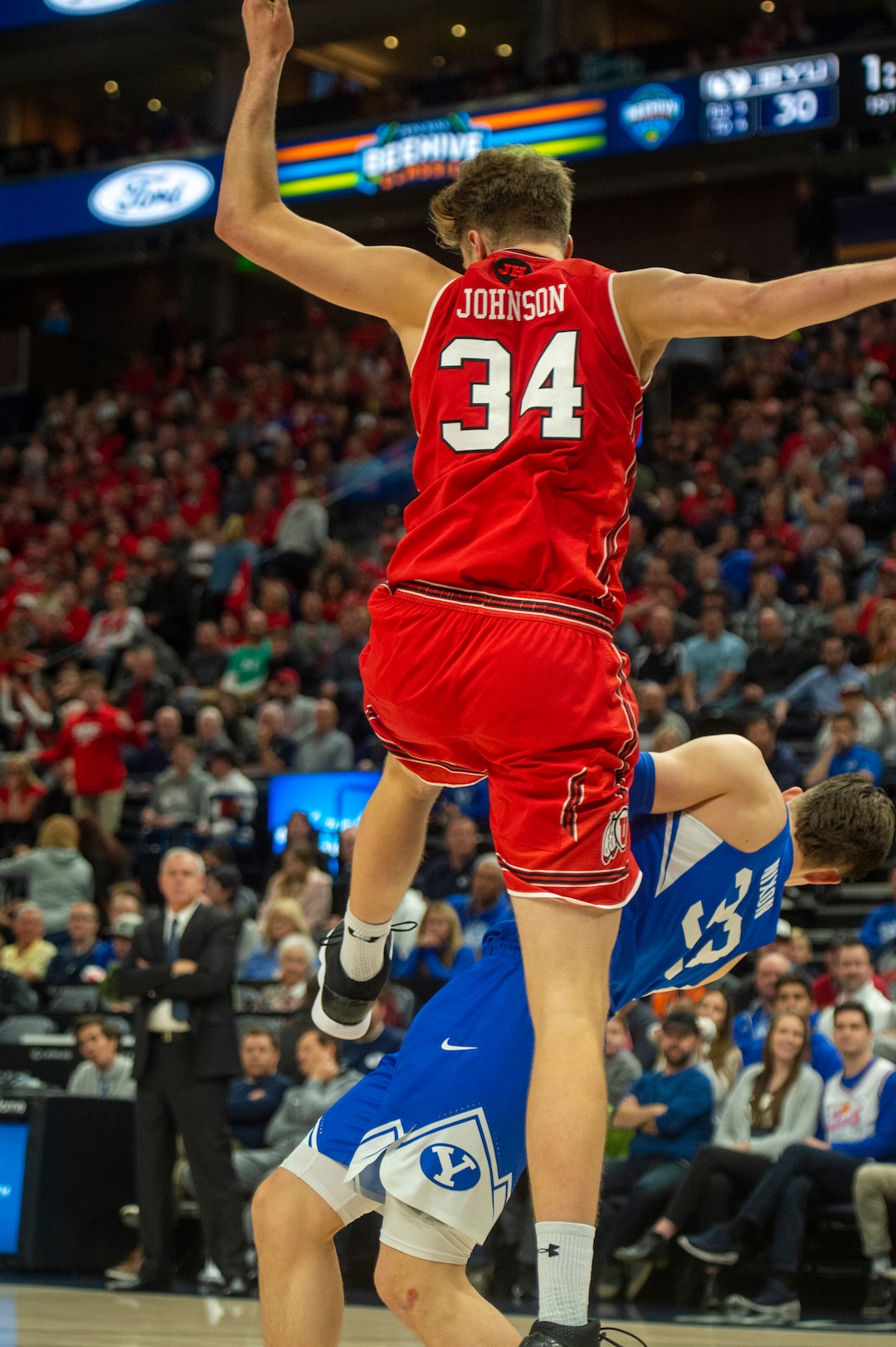 (Rick Egan  |  The Salt Lake Tribune)   Utah Utes center Jayce Johnson (34) dunks the ball and takes out against the Brigham Young Cougars forward Dayton Nixon (33) on the play in basketball action in the Beehive Classic, between against the Brigham Young Cougars and Utah Utes, a the Vivint Smart Home Arena, Saturday December 8, 2018.