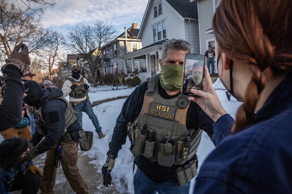 (David Guttenfelder | The New York Times) Federal agents during an operation where two people were arrested at a home in Minneapolis, on Tuesday, Jan. 13, 2026.