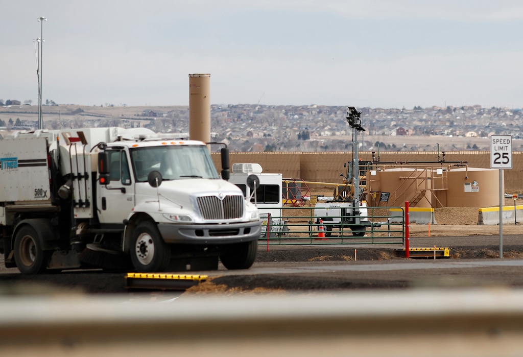 (David Zalubowski | AP Photo) In this Feb. 28, 2019, photograph, workers toil on the site of a construction project for a well pad near Interstate 25 in Broomfield, Colo. Frustrated residents of a Denver suburb say state law is forcing them to participate in a major oil and gas drilling project against their wishes, so they launched legal challenges with potentially significant consequences for the industry. Backed by a federal judge, they have a chance this week to ask state regulators to block multiple wells planned within about 1,300 feet of homes in the city of Broomfield.