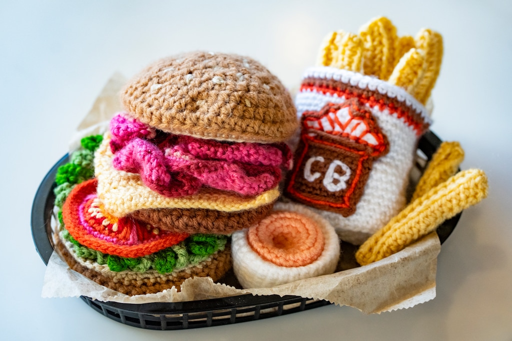 (Rick Egan | The Salt Lake Tribune) Elaina Maragakis Simos  crocheted a lifesize Crown Burger and fries and gifted it to Mike Katsanevas, the owner of the Highland Drive location of Crown Burger, on Monday, May 19, 2025.