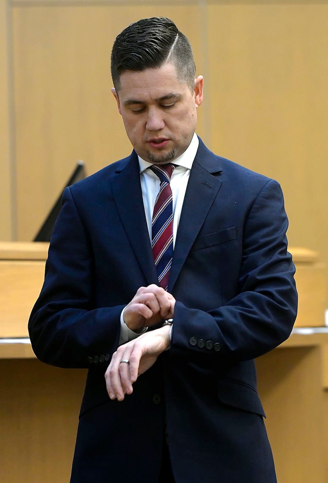 Prosecuting attorney Spencer Walsh checks his watch while waiting for jury instructions to be finalized during Torrey Green's rape trial, Wednesday, Jan.16, 2019 in Brigham City, Utah. Green is accused of raping multiple women while he was a football player at Utah State University. (Eli Lucero/Herald Journal via AP)