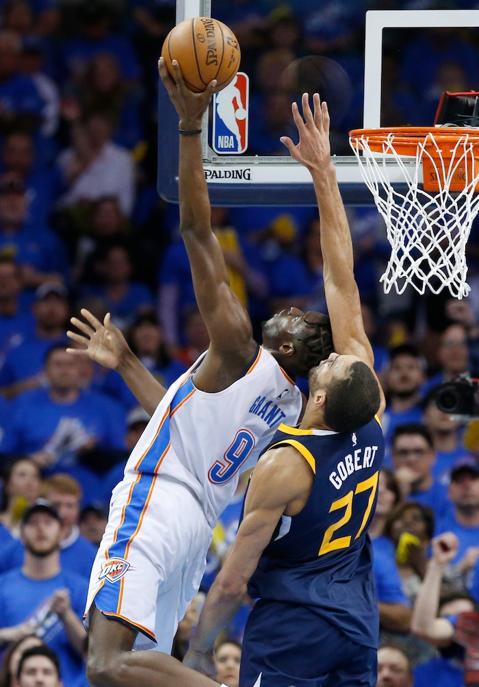 Oklahoma City Thunder forward Jerami Grant, left, shoots as Utah Jazz center Rudy Gobert (27) defends in the second half of Game 1 of an NBA basketball first-round playoff series in Oklahoma City, Sunday, April 15, 2018. (AP Photo/Sue Ogrocki)