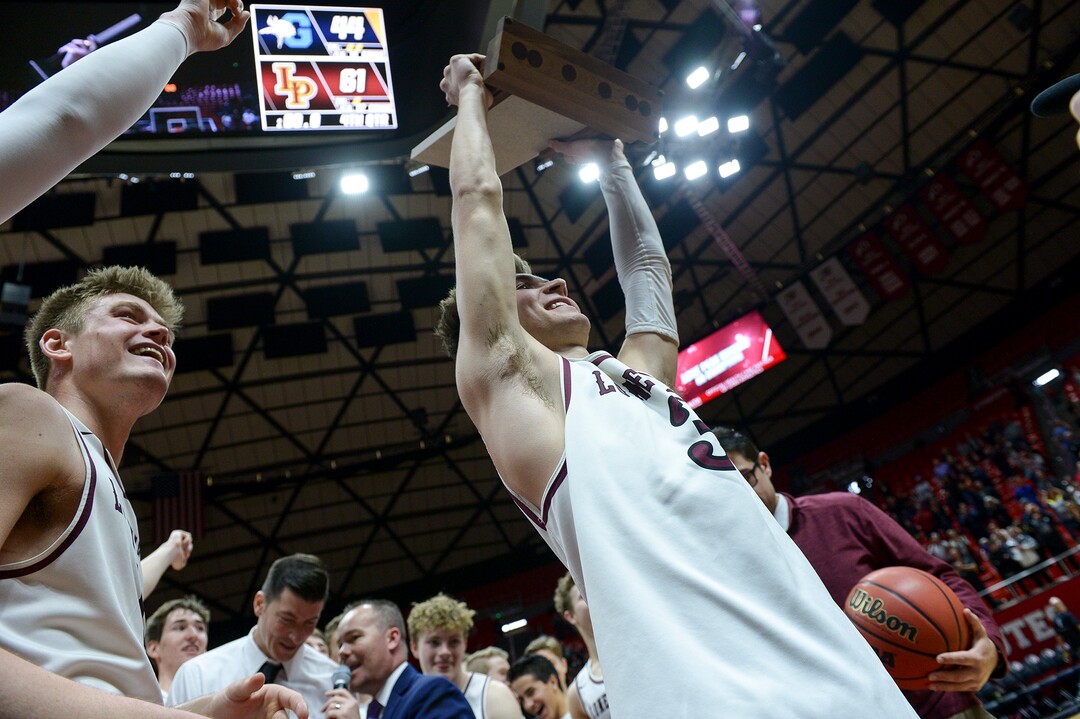 (Leah Hogsten  |  The Salt Lake Tribune) Lone Peak's Steven Ashworth (03) hold the trophy as the team celebrates the win. Lone Peak defeated Pleasant Grove 61-44 to win the 6A High School BoysÕ Basketball Tournament Championship at the Jon M. Huntsman Center in Salt Lake City, Saturday, March 3, 2018. 