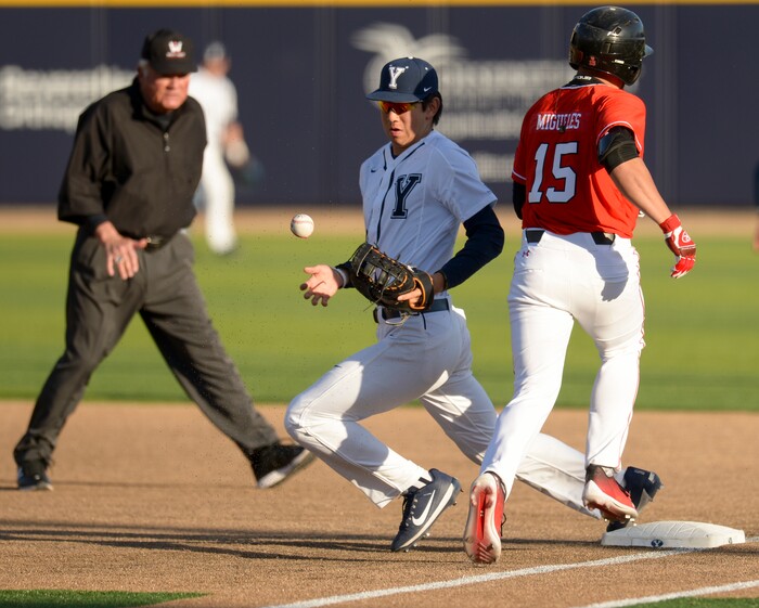 (Leah Hogsten  |  The Salt Lake Tribune) BYU's first baseman Brian Hsu fumbles the catch as Utah's Erick Migueles makes it to first base as Brigham Young University hosts University of Utah at Miller Park, Tuesday, April 24, 2018 in Provo.