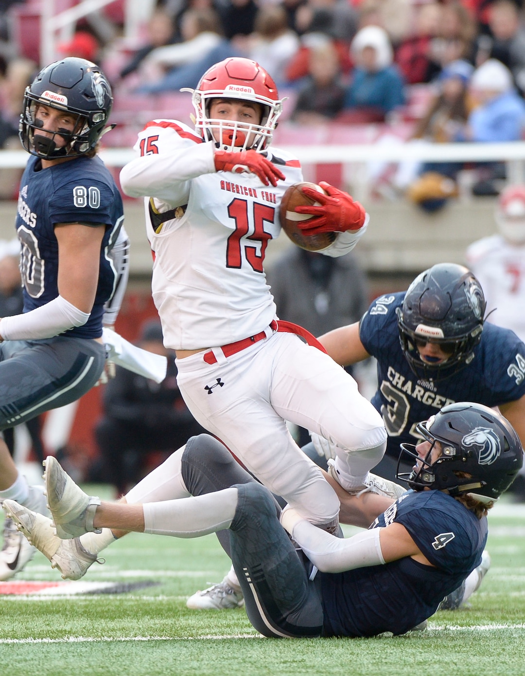 (Leah Hogsten  |  The Salt Lake Tribune)  American ForkÕs Devin Downing is brought down by Corner CanyonÕs Ryan Cahoon. Corner Canyon High School takes on American Fork High School during the 6A State Championship football title, Nov. 22, 2019 at Rice-Eccles Stadium.