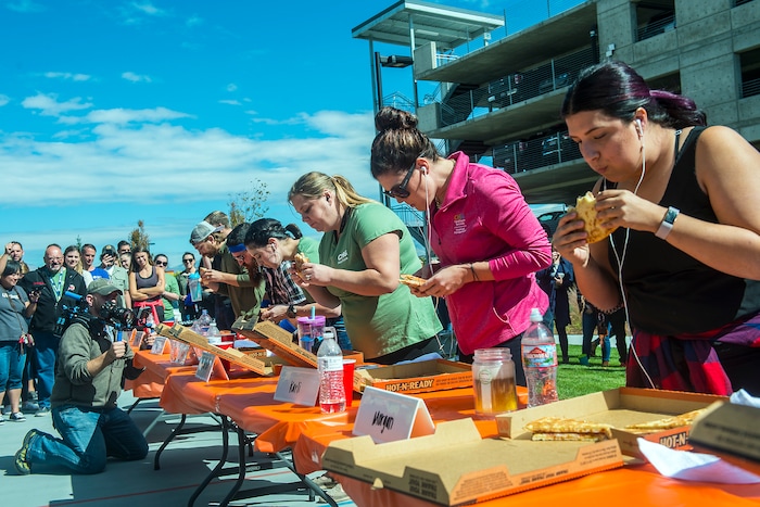 (Chris Detrick | The Salt Lake Tribune) Employees compete in a pizza eating competition during a fundraiser for United Way at CHG Healthcare Wednesday, September 20, 2017.