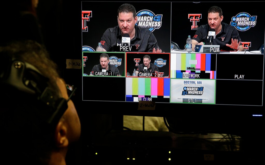 A technician watches a monitor as Texas Tech coach Chris Beard speaks during a news conference at the NCAA men's college basketball tournament, Saturday, March 24, 2018, in Boston. Texas Tech faces Villanova in a regional final on Sunday. (AP Photo/Elise Amendola)