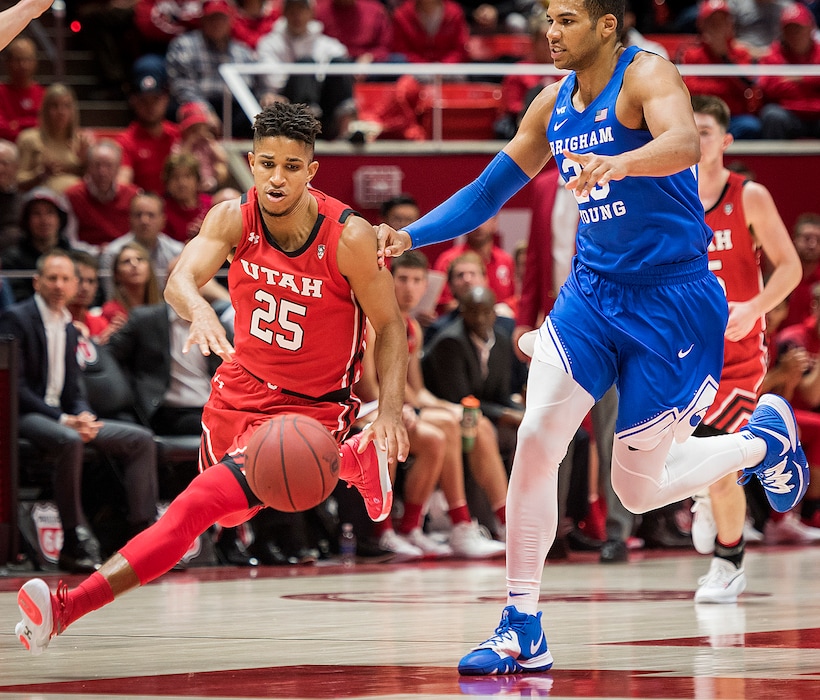 (Michael Mangum | Special to The Tribune) Utah Utes guard Alfonso Plummer (25) drives past Brigham Young Cougars forward Yoeli Childs (23) during their game at the Huntsman Center in Salt Lake City on Wednesday, Dec. 4, 2019.
