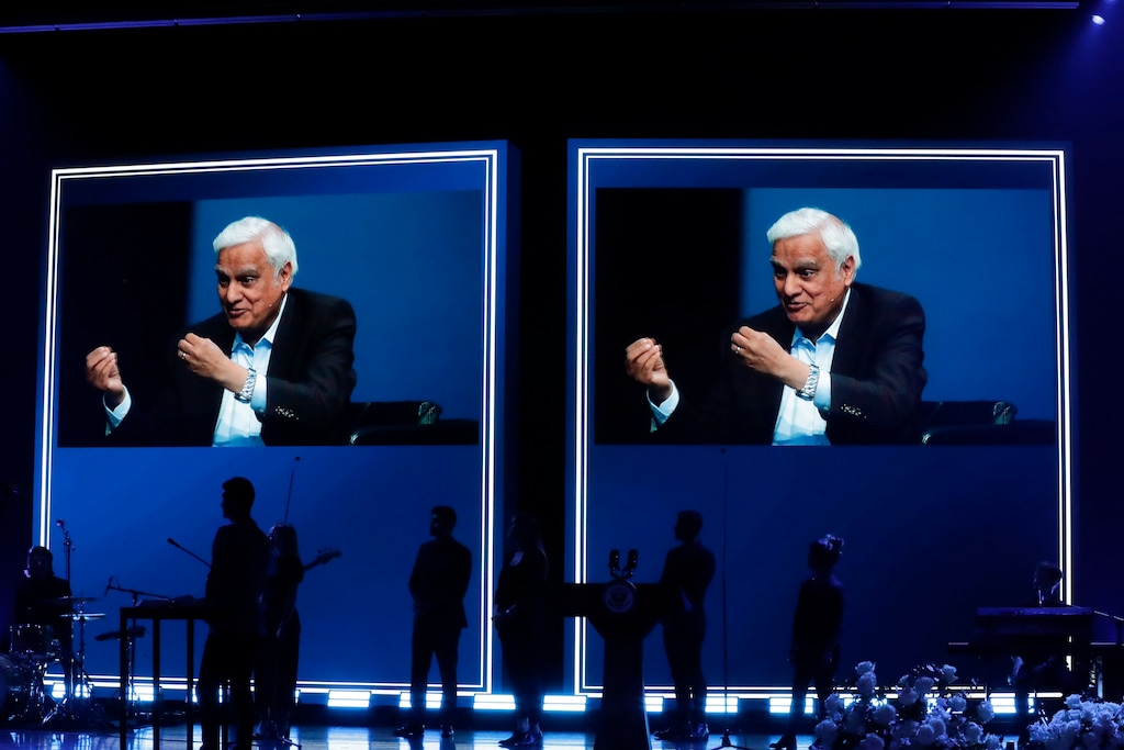 FILE - In this May 29, 2020 file photo, images of Ravi Zacharias are displayed in the Passion City Church during a memorial service for him in Atlanta. A law firm's investigators have released a scathing report on their four-month investigation of alleged sexual misconduct by Zacharias, who founded a global Christian ministry that bears his name. (AP Photo/Brynn Anderson, File)