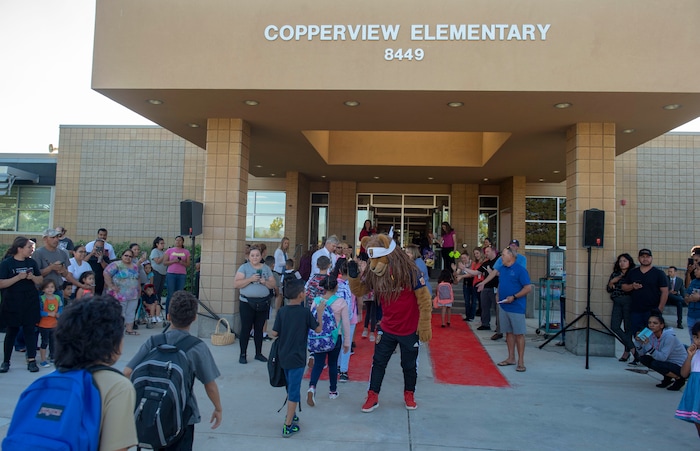 (Rick Egan | The Salt Lake Tribune) Real Salt Lake mascot Leo the Lion gives high-fives to students as they walk the red carpet on the first day of school at Copperview Elementary School in Midvale, Monday, Aug. 19, 2019.