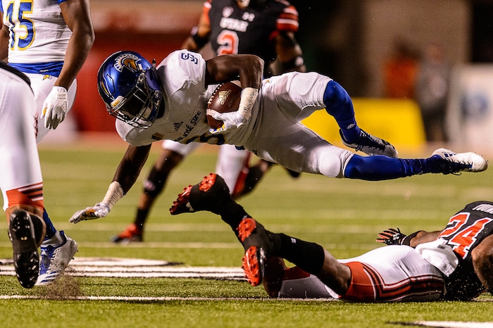 (Trent Nelson | The Salt Lake Tribune) San Jose State Spartans running back Zamore Zigler (34) is tripped up as the Utah Utes host the San Jose State Spartans, NCAA football at Rice-Eccles Stadium in Salt Lake City, Saturday September 16, 2017.