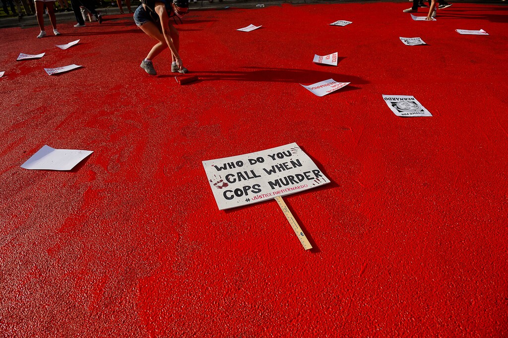 (Trent Nelson | The Salt Lake Tribune) Protesters paint the street in front of the Salt Lake County District Attorney's office while marching against police brutality in Salt Lake City on Saturday, June 27, 2020.