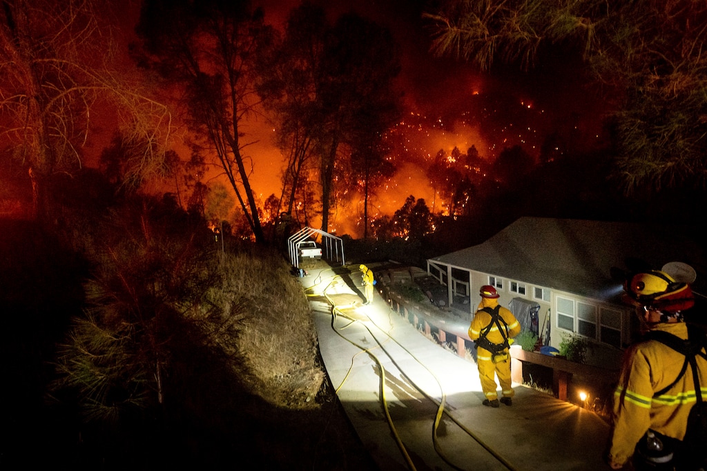(Noah Berger | AP photo)
Firefighters protect a home in the Berryessa Estates neighborhood of unincorporated Napa County, Calif., as the LNU Lightning Complex fires burn on Friday, Aug. 21, 2020. The blaze forced thousands to flee and destroyed hundreds of homes and other structures.