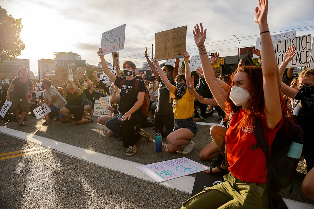 (Trent Nelson  |  The Salt Lake Tribune) Protesters kneel in front of police during a protest against police brutality in Salt Lake City on Monday, June 1, 2020.