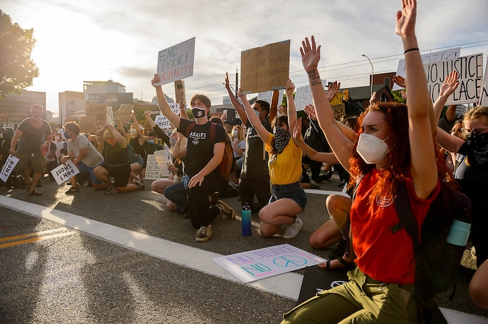 (Trent Nelson  |  The Salt Lake Tribune) Protesters kneel in front of police during a protest against police brutality in Salt Lake City on Monday, June 1, 2020.